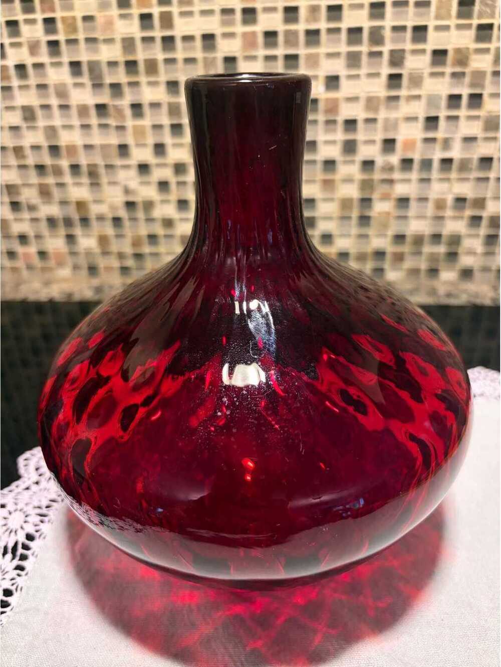 This is a mid-century Wheaton ruby red glass honeycomb thumbprint bottle.